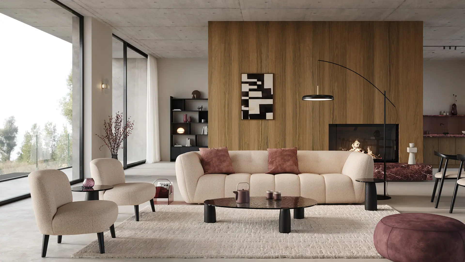 Fauteuil Aviano en tissu clair avec pieds noirs, dans un salon contemporain avec canapé beige, table basse noire et cheminée.