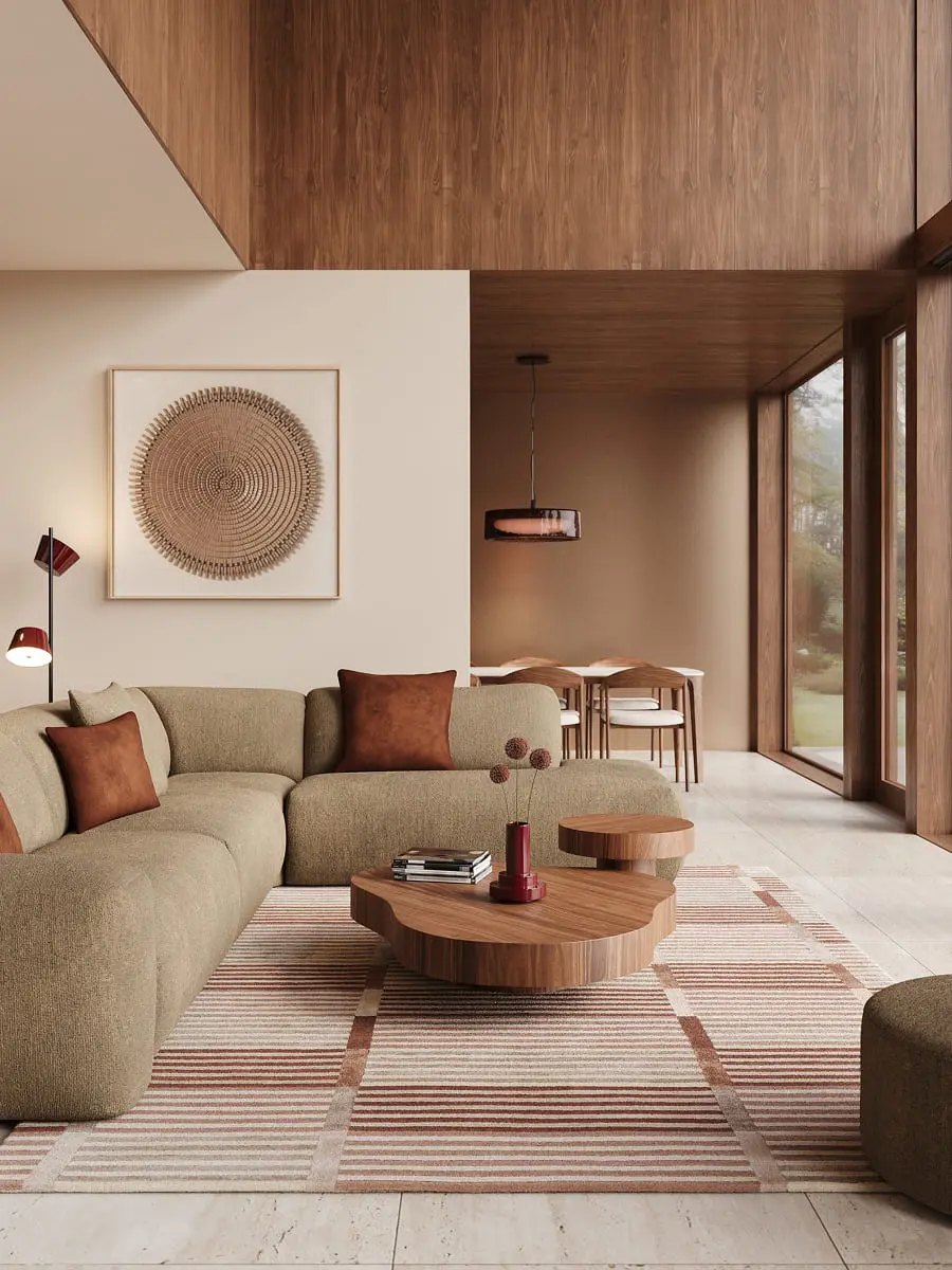 Espace de vie chaleureux avec canapé d'angle vert, tables basses organiques en bois et grandes fenêtres, dans un intérieur avec des accents en bois.