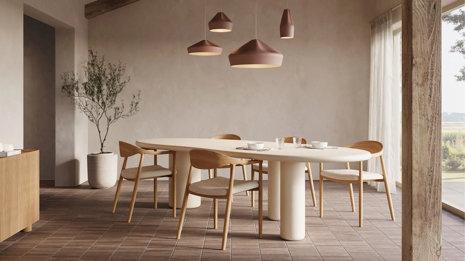 Lange Artisano eettafel met afgeronde vormen en centrale poten, in een warme ruimte met houten balken en lichte stoelen.