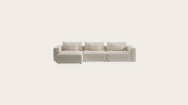 Beige modulaire Duomo-zetel met brede armleuningen, diepe zit en losse rugkussens, vrijstaand op een lichte achtergrond.