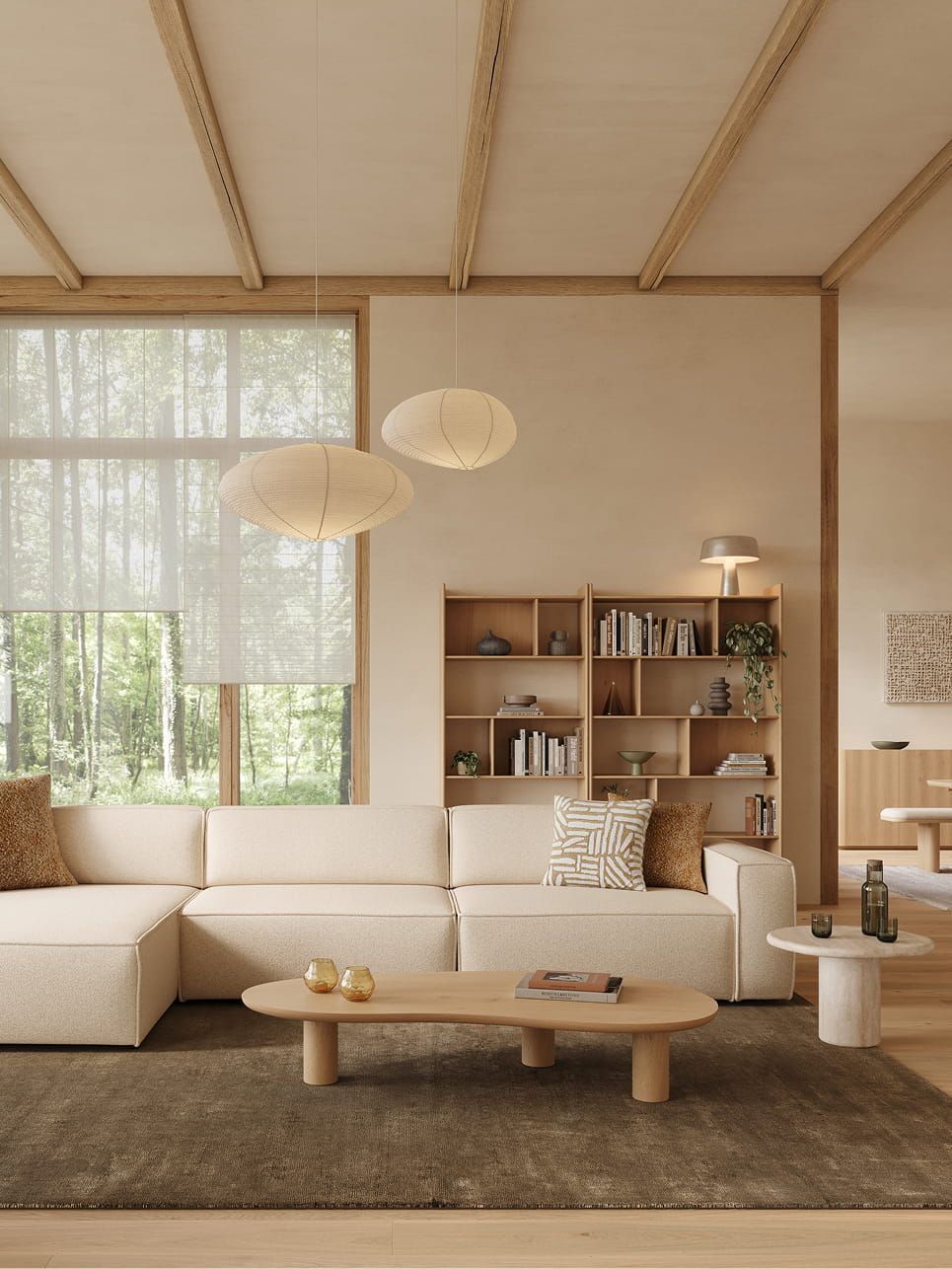 Artisano blob salontafel met organische vorm en lichte afwerking, voor een beige hoekzetel op een donker tapijt.