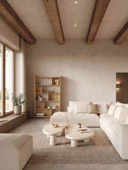 Tapis Lavora beige dans un salon apaisant avec canapé modulaire, tables basses organiques, étagère en bois et lumière naturelle douce.