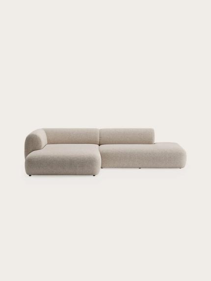 Tortona modulaire hoekzetel met chaise longue links, afgeronde vormen en lichtbeige stofbekleding.