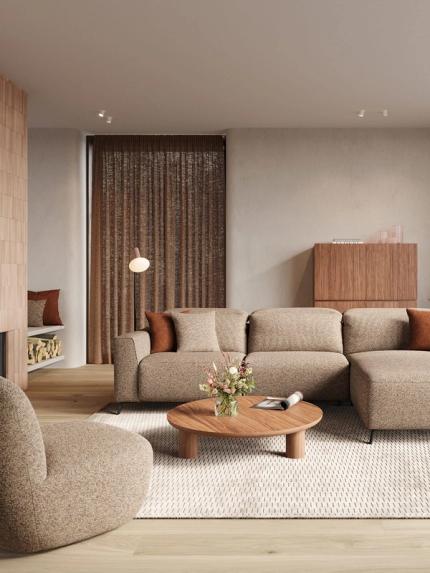 Beige modulaire zetel Monza met chaise longue in warme woonkamer, ronde houten salontafel en kussens.