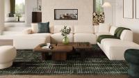 Salon lumineux avec un canapé modulaire beige, des tables basses en bois foncé et un tapis vert, disposés devant une cheminée encastrée.