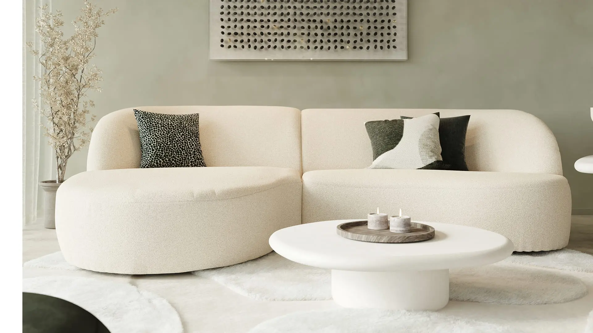 Table basse Artisano en forme de galet blanche devant un canapé beige dans un intérieur moderne et apaisant.