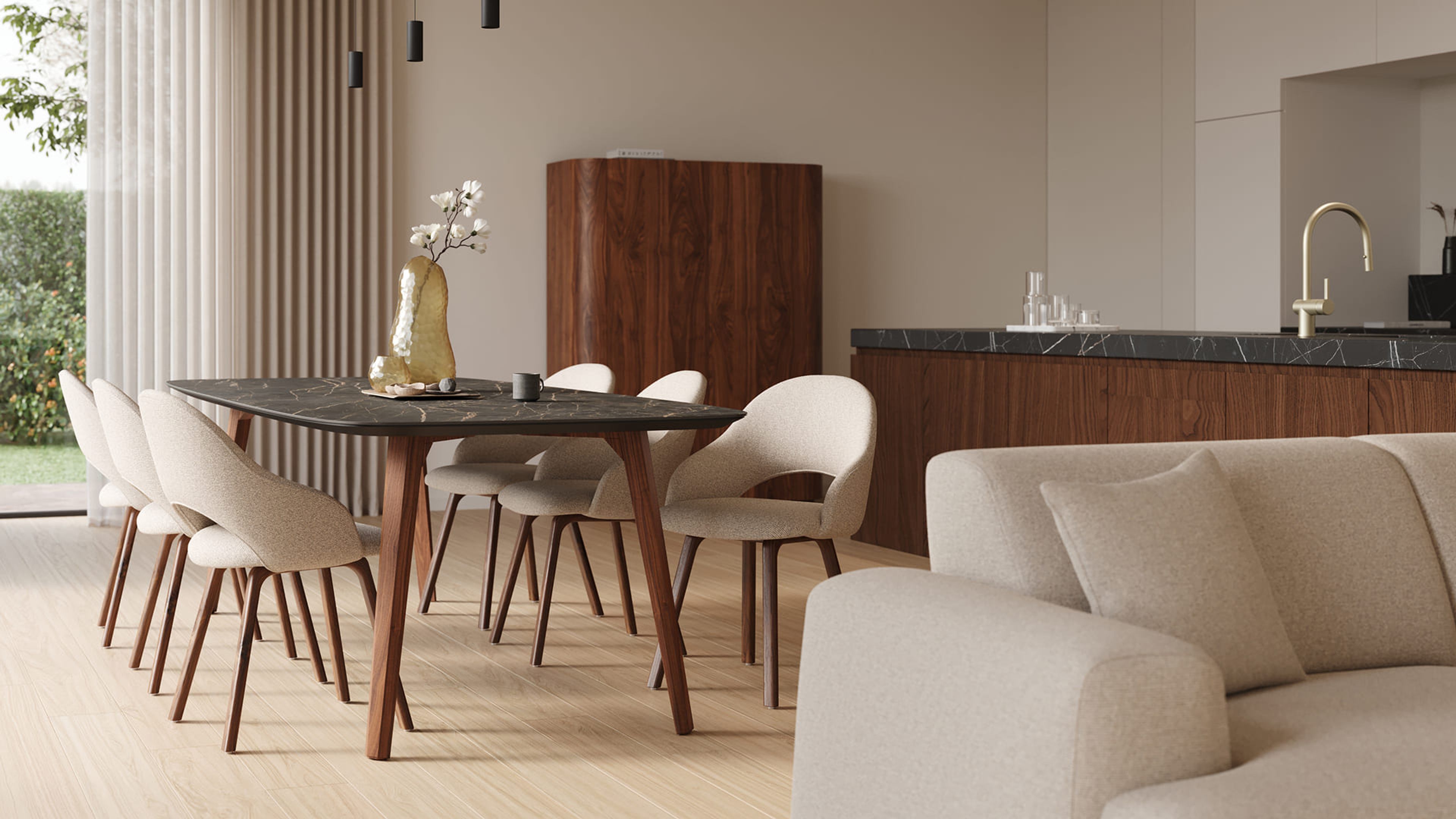 Espace repas avec table à manger en marbre foncé, six chaises rembourrées beige et pieds en bois, cuisine ouverte avec meubles en bois et robinet en laiton.