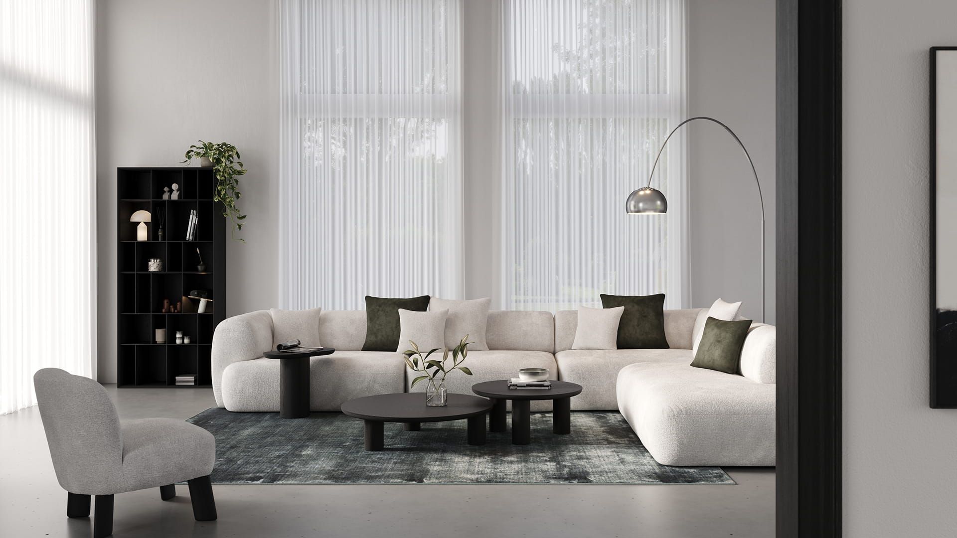 Arezzo fauteuil in licht grijze stof met zwarte poten, in een stijlvolle woonkamer met een grote beige bank, zwarte salontafels en een booglamp.