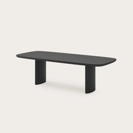Table à manger Amato en bois noir avec des coins arrondis, plateau allongé et deux pieds larges et arrondis.
