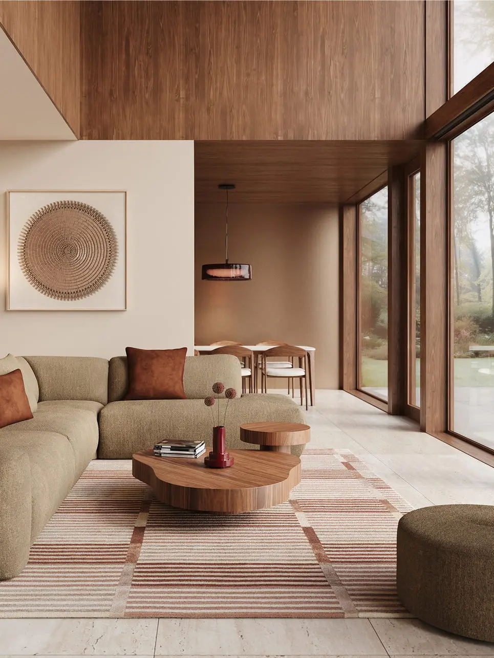 Pouf Tondo en tissu vert près d’un canapé d’angle modulable, avec table basse en bois sur un tapis rayé.
