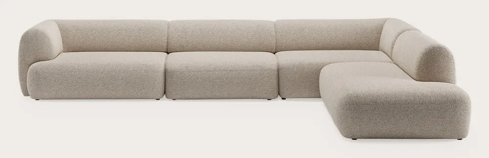 Canapé d’angle modulaire avec plusieurs modules d’assise et accoudoirs arrondis, revêtu de tissu beige clair sur fond neutre.