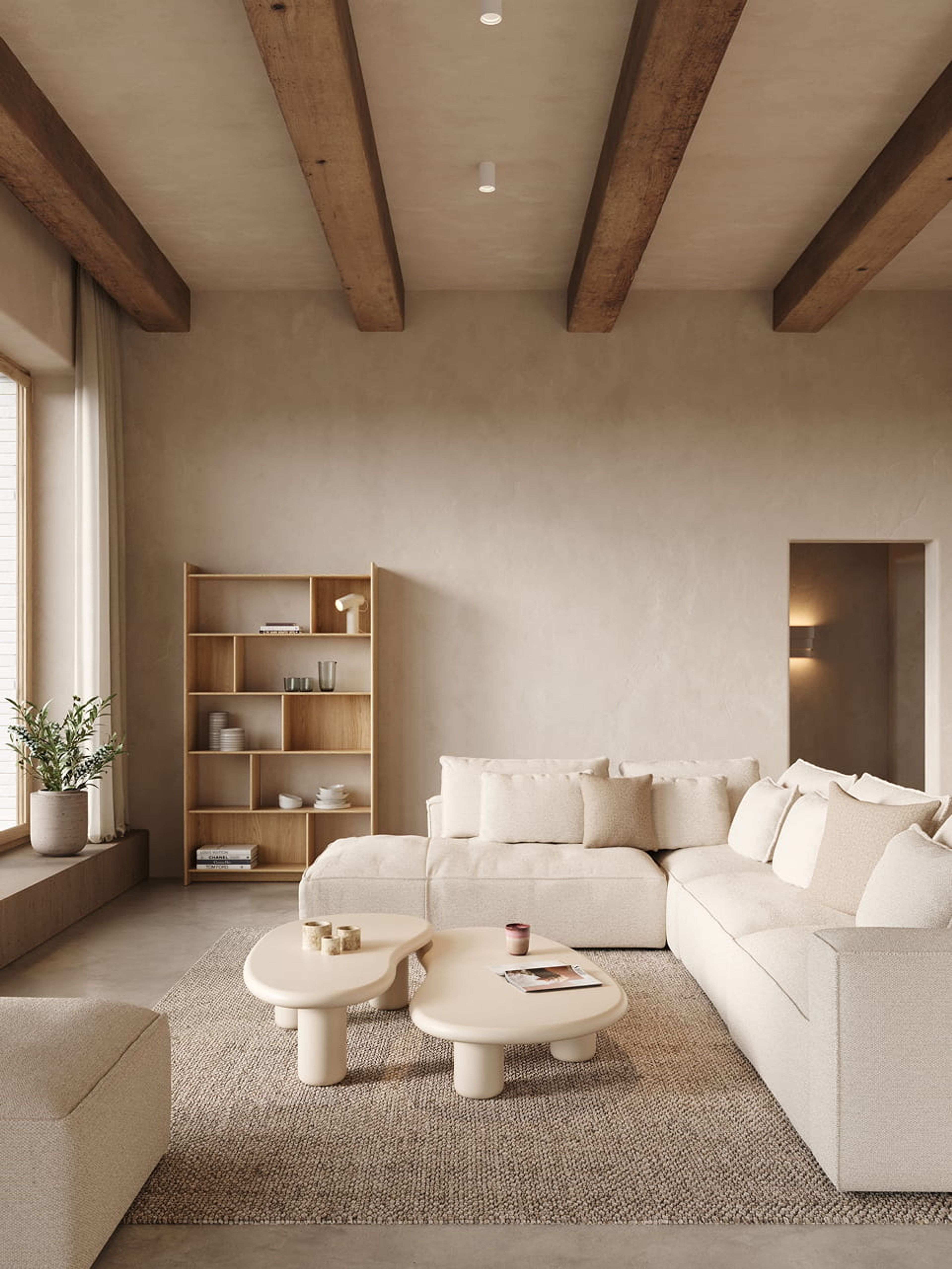 Artisano blobvormige salontafel in licht beige op een tapijt in een warm, minimalistisch interieur met zetel en rek.