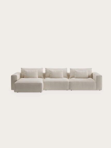 Canapé modulaire Duomo beige avec accoudoirs larges, assise profonde et coussins de dos amovibles, librement posé sur un fond clair.
