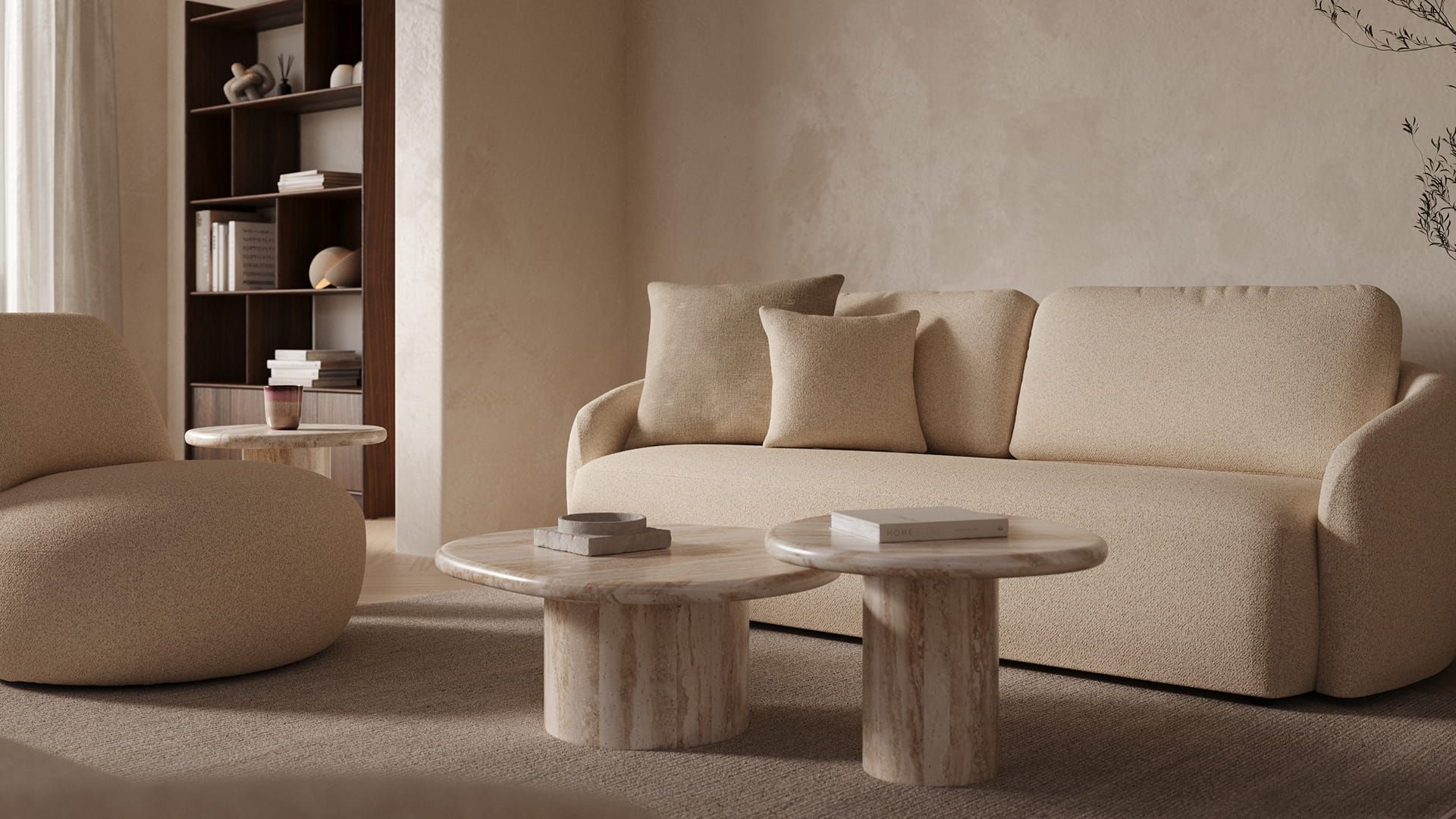 "Canapé Tomar en tissu beige doux avec des formes arrondies, tables basses en marbre, lampe suspendue et grande bibliothèque en bois dans la niche.