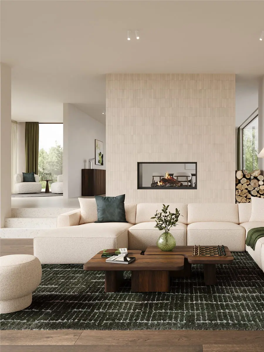 Beige modulaire zetel Faro in lichte woonkamer met open haard, houten salontafels, groen tapijt en grote ramen.